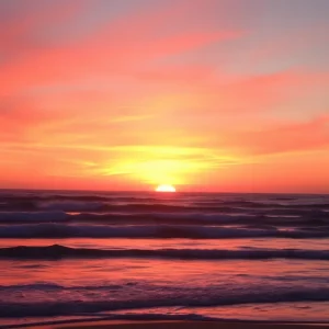 A beautiful sunset over a California beach with waves.
